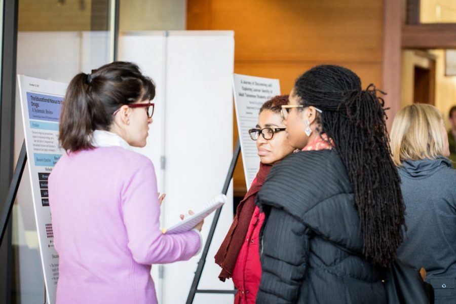 researchers talking at uw madison poster fair