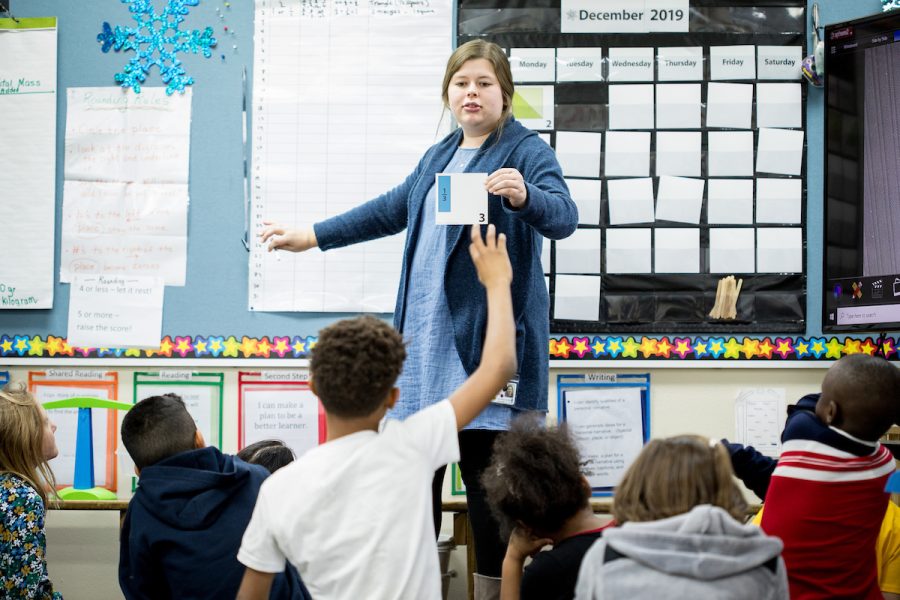 Student teacher speaking in front of children in a classroom