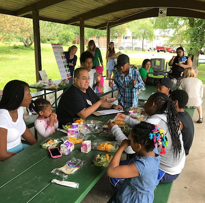 Anthony Hernandez conducts a survey interview to gather perspectives on the summer food program.