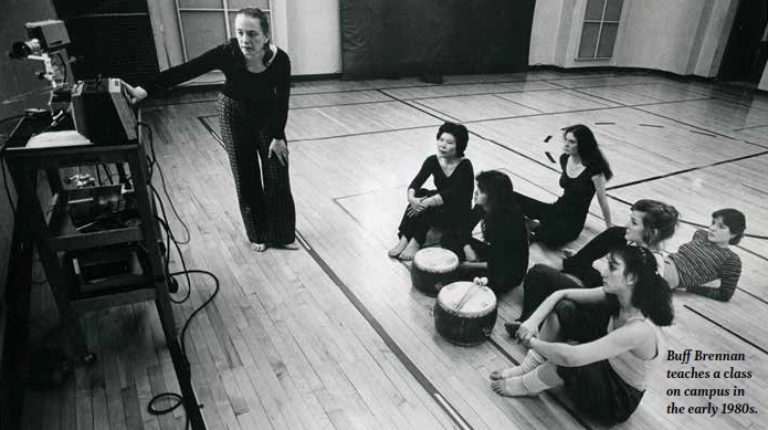 teacher instructs dance class students in a studio in the 1980s