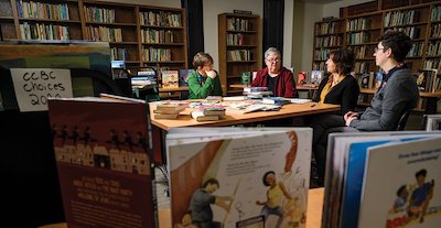 Librarians Megan Schliesman, Kathleen T. Horning, Merri V. Lindgren, and Madeline Tyner each evaluates upwards of 1,000 volumes a year.